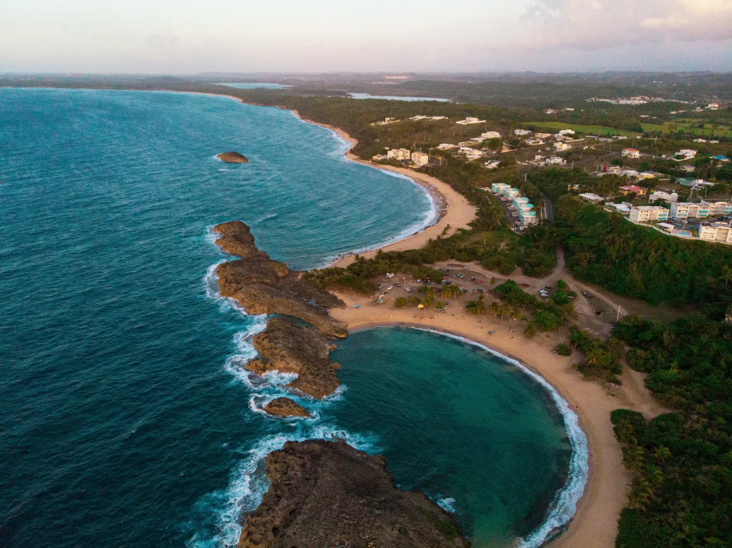 Dramatic aerial view of Puerto Rico's rugged coastline meeting the ocean.