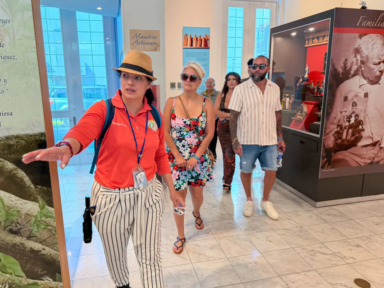 A guide leading travelers through a local cultural museum.