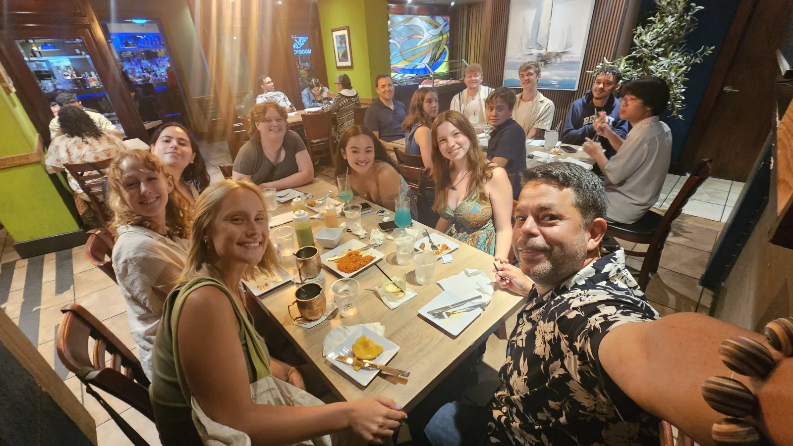 A tour group sharing dinner at a restaurant.